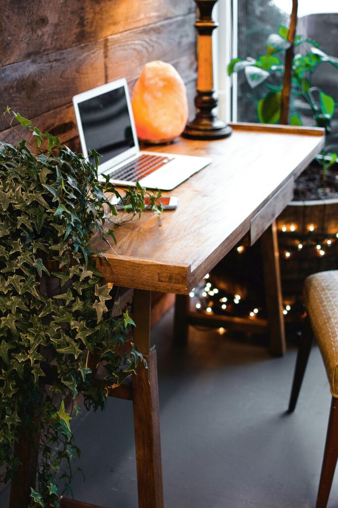 Himalayan Salt Lamp Near Laptop On Wooden Table